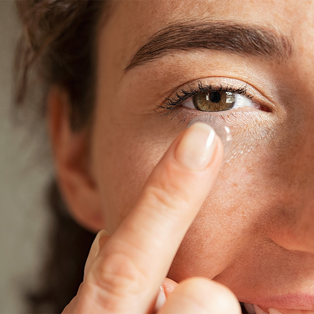 woman putting in contact